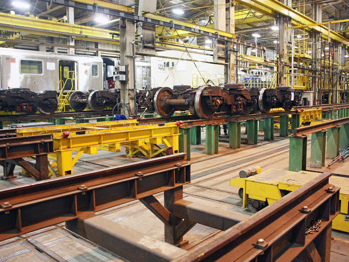 On the lower track, workers place wheels, also called "trucks." Just like the shells, Kawasaki works on both brand-new and refurbished trucks. The wheels are 32 inches in diameter and each truck can weigh around 8.5 tons.