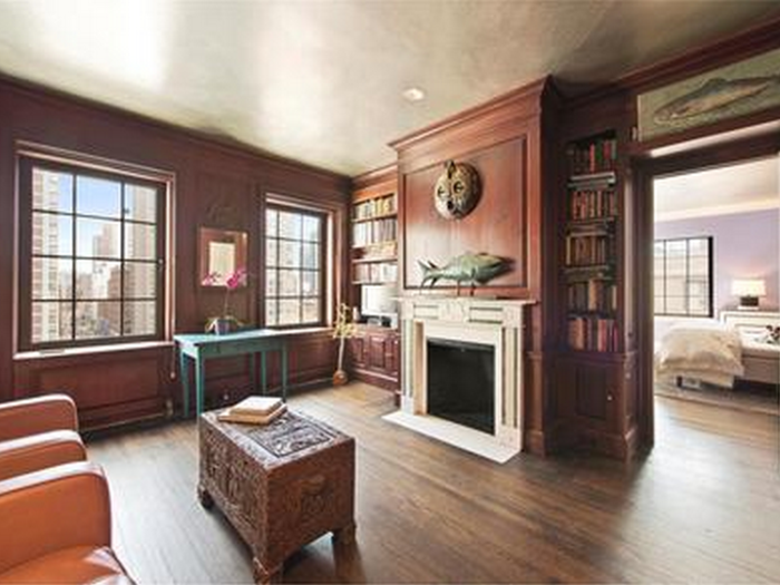 The library features mahogany paneling and a wood-burning fireplace.