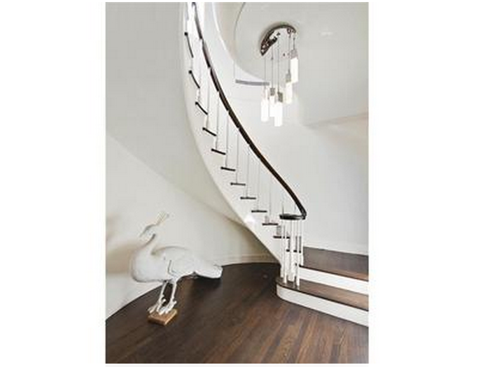 The oval shaped entry foyer opens to a staircase.