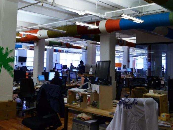 The big, open office space where Etsy employees sit is colorful and bright. Note the pipes, which have been yarn-bombed.