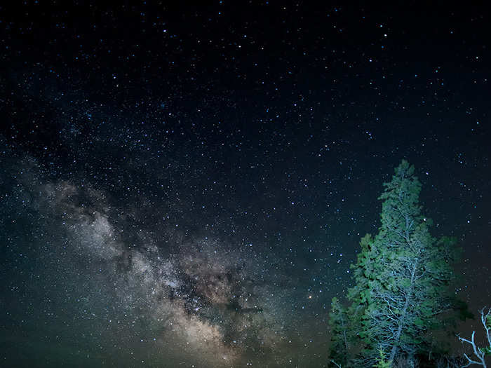 Taken in a similar location to “A Colorful Night” on Park Loop Road in Acadia National Park, “Night’s Glow" coalesces Earth with the cosmos. The Milky Way Galaxy’s band meets a foggy, grey-blue mist along the lake’s rocky coastline.