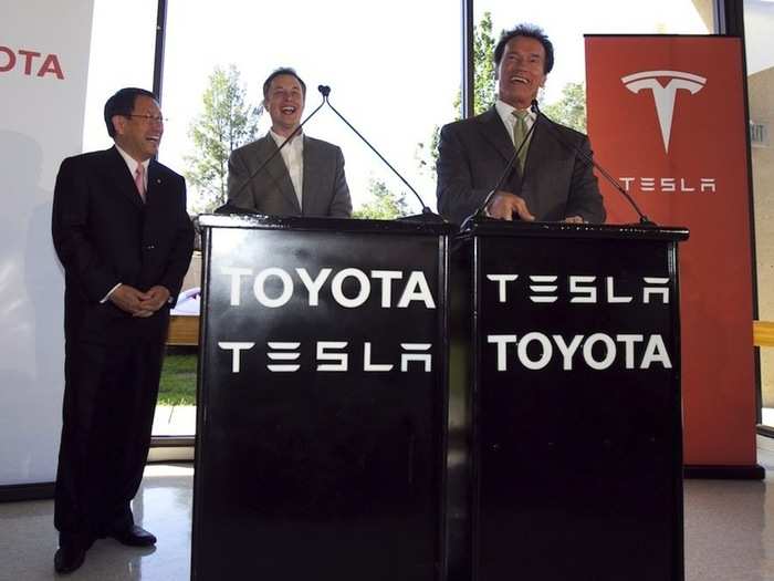 He shared a laugh with California Governor Arnold Schwarzenegger and Toyota CEO Akio Toyoda at a press conference announcing Toyota would take a $50 million stake in Tesla.