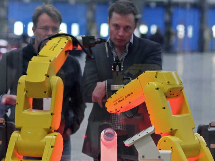Elon Musk stares down robots.