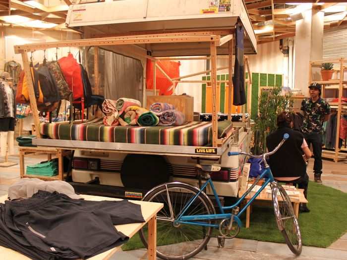 An old camper is set up in the middle of the shop to display merchandise.