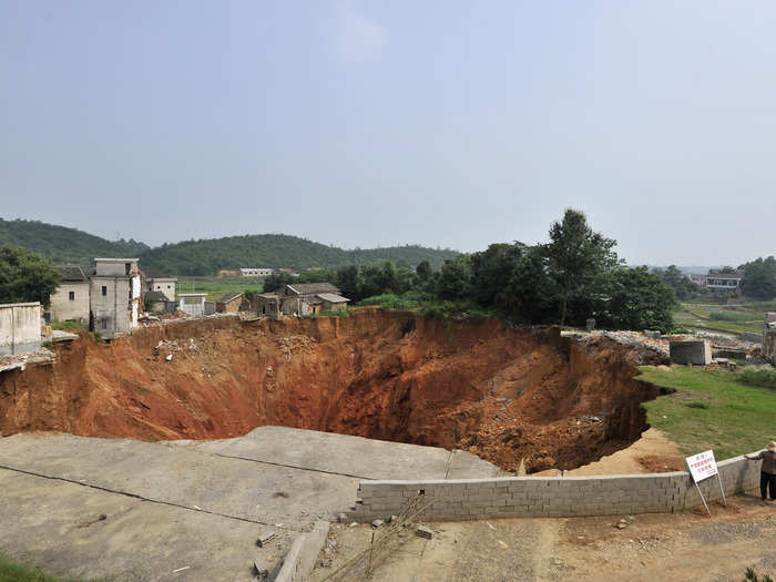 This sinkhole in China is a staggering 492 feet deep and has been growing since it first opened in 2010. It has destroyed 20 homes so far.