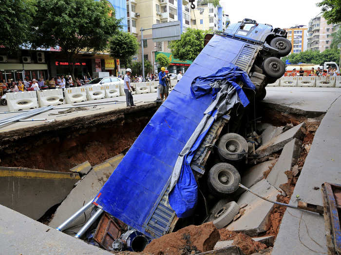 A sinkhole opened up on this street in China in August, swallowing a giant truck.