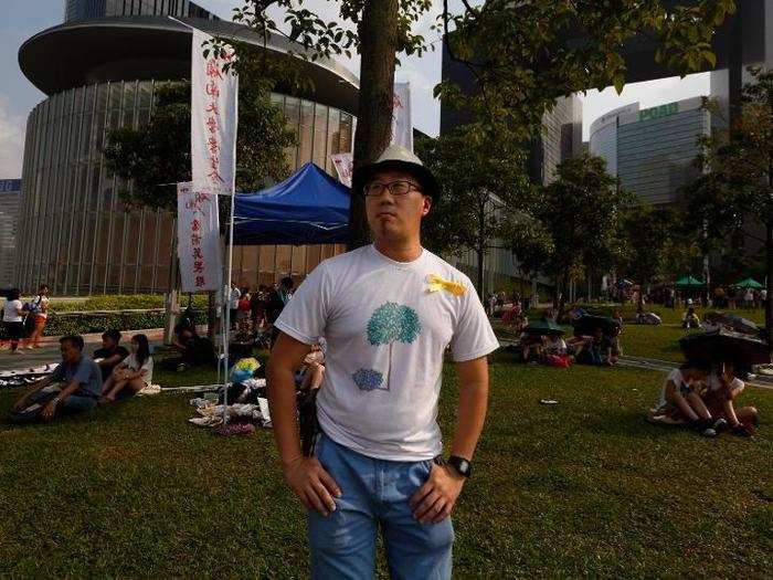 Auyeung Tung, 36, an artist, also poses for a photograph prior to the main protests. Auyeung said, "Lives of the grassroots will be improved when there is true democracy."
