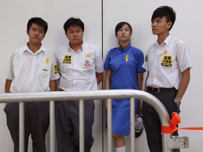 (From L-R), Jack, 17, Paul, 18, Agnes, 17 and Mo, 19, pose for a photograph together. The four secondary school students blame the government for not promising a true democracy.