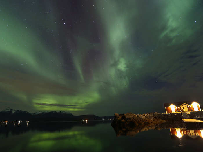 They concentrate around the poles because the solar wind is attracted there by the Earth