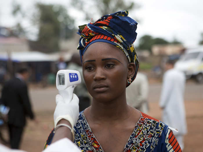 Instead, officials try to intercept potential cases. Health workers check the temperatures of people crossing the border from Guinea, one of the most afflicted countries, into Mali.