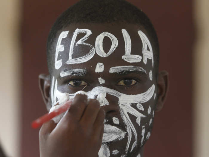 Schools are a prime place for public health campaigns. This actor plays the role of Ebola in a performance as part of a public awareness campaign at a school in Abidjan, Cote d