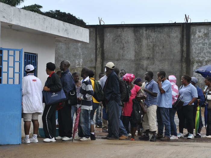 Constant vigilance is crucial to keeping the disease at bay. Here, a group of health care workers waits in line to have their temperatures taken before starting the day