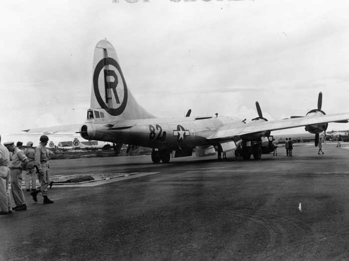 Once "Little Boy" is ready, the Enola Gay, a Boeing B-29 Superfortress bomber, is reversed and positioned over the trench.