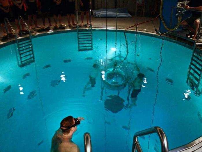 At first, future submariners are loaded into a pressurized section 15 feet below the water in the escape trainer ...