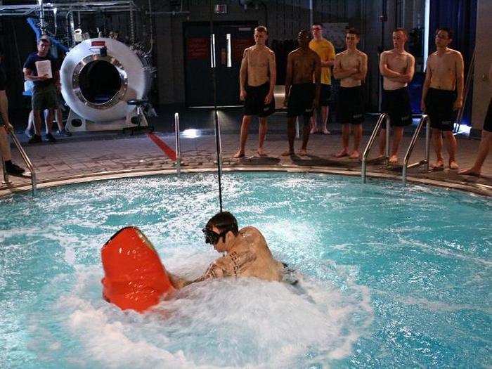 ... and on the second round of training, the students are loaded into a pressurized chamber 37 feet below water that is identical to what a submariner would face within an actual vessel. Once the chamber is pressurized, the submariner is shot through the water to the surface at 600 feet per minute, just as in an actual submarine escape.