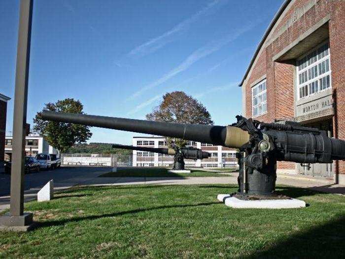 Six-inch deck guns from a World War II-era submarine sit outside the gymnasium, among other reminders of military history.