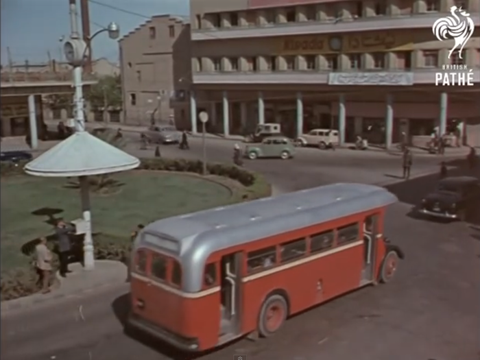 ... a city where "the tempo of an age-old way of life contrasts with the swifter rhythm of the new." The narrator declares that "the twentieth century has come to Baghdad, with steel and concrete, with shining cars and wide streets."