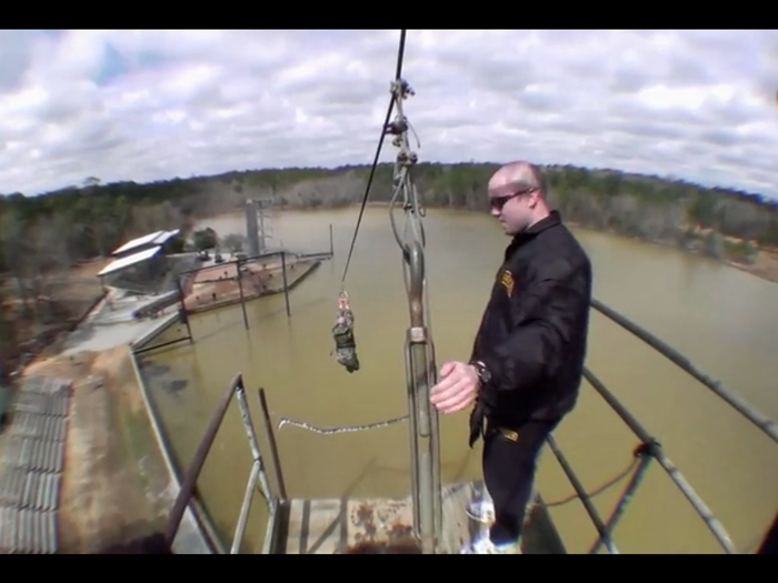 The guys needs to climb a ladder to the narrow bridge, naturally walking across and shimmying down a zip-line on the far side.