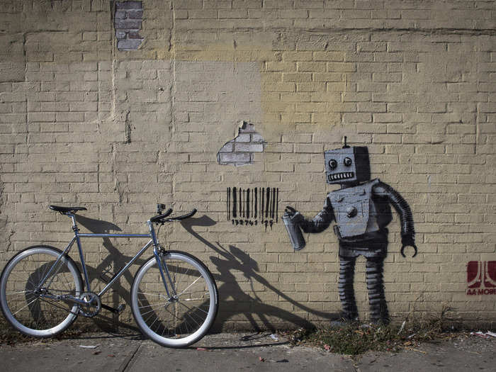 This robot graffiti artist tagging a wall with a barcode (what else?) was part of Banky