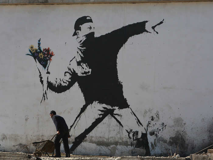 This piece, stenciled on a wall in Bethlehem, is one of Banksy