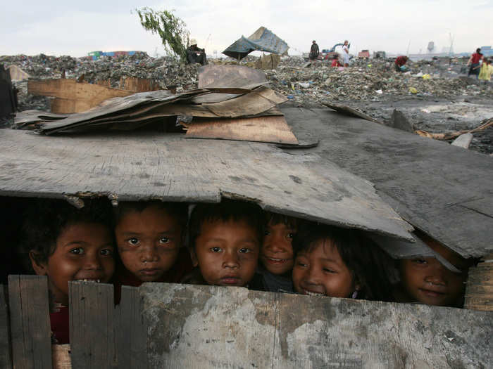 These children have made a makeshift playhouse out of materials they found at this dump site, where they live, in Manila, Philippines.