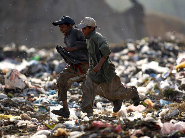 These boys run through a garbage dump outside Islamabad, Pakistan.