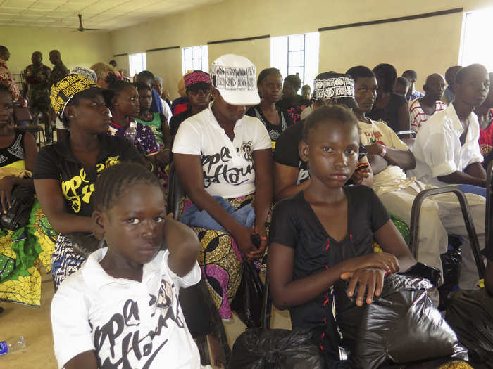 In this photo, a group of survivors attend a ceremony celebrating their discharge from a clinic in Freetown, Sierra Leone.