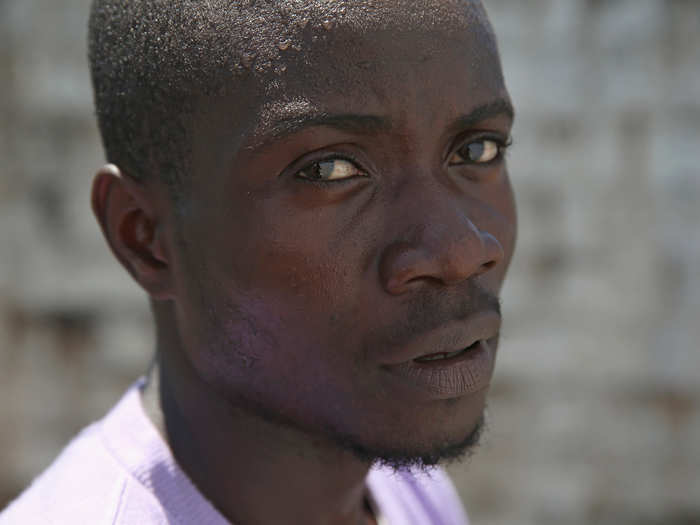 Construction worker Mohammed Wah, 23, thinks he first got sick caring for his nephew. Here he stands in the low-risk section of a MSF clinic in Liberia.