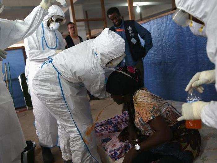 In this training session, an Ebola survivor participating in a two-week course pretends to vomit to help other newly-trained healthcare workers prepare to deal with sick patients. Many of these new workers will staff treatment centers being built by the US military in Liberia.