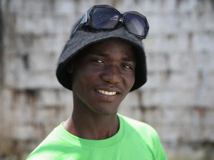 Emanuel Jolo, 19, thinks he got sick while preparing his father for his funeral. Here he