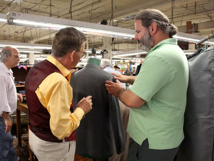 Tod Greenfield (right), Martin’s son and the factory’s co-owner, estimates that 100 employees handle each suit from the time it’s a pile of fabric until it’s a completed garment. Each of the 120 workers is responsible for a handful of tasks.