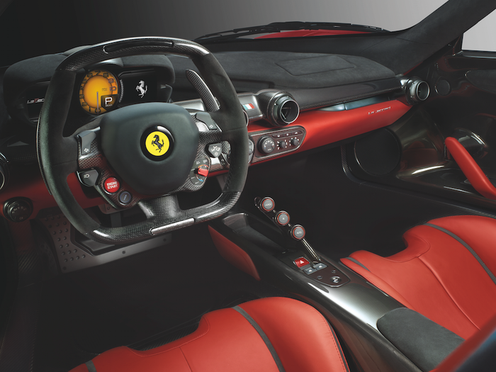 INTERIOR: The LaFerrari’s interior is similarly minimalistic. We like the unorthodox, three-button (Launch, R, Auto) gear shifter, big shifter paddles, and simple controls. But we dock points for the almost square steering wheel.