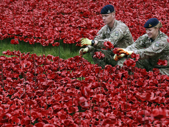 Two active British soldiers help finish the installation.