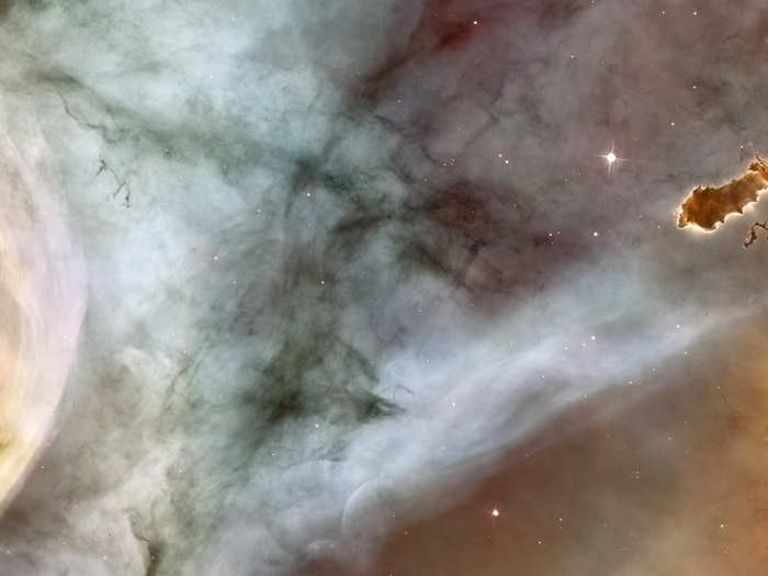 Unlike in the previous Hubble image, the evaporating gaseous globule on the right of this one has completely detached from its host gas cloud. This is a close-up image of the Carina Nebula, and that free-floating EGG is known as the "caterpillar." You can see that the edges of the caterpillar are illuminated, indicating that it