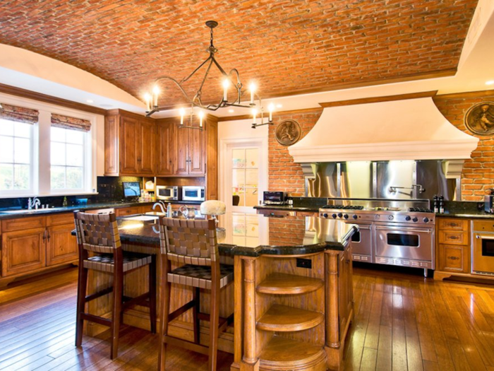 The kitchen has a brick ceiling and a large island.