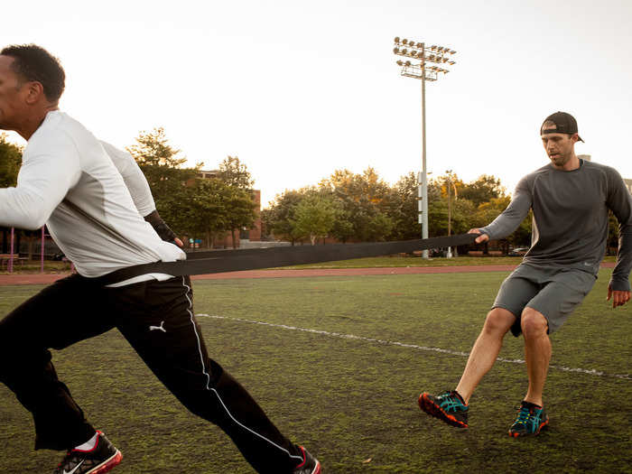 Bozeman also included some different exercises to build up strength, like these "resistance sprints." During the exercise, one person wears a large resistance band and attempts to sprint, while another tries to stop them by holding the band.