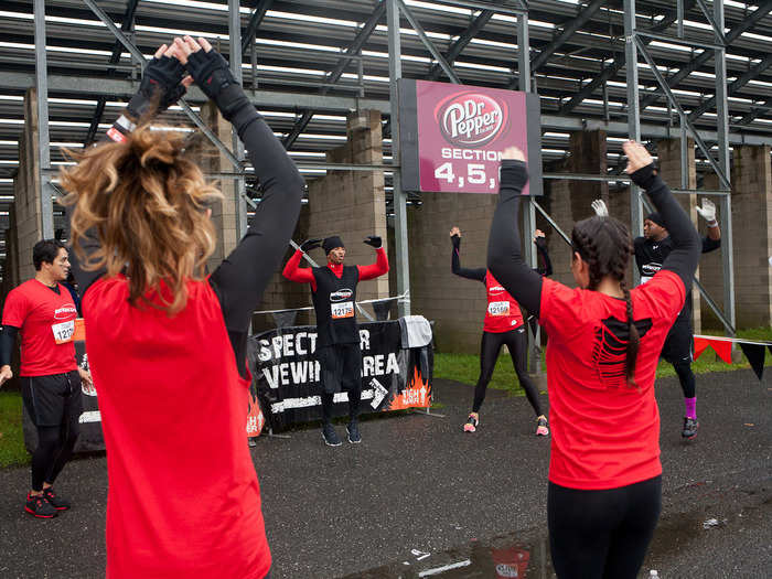 Bozeman led the team through a series of stretches and sprints in the warm up area. Outside the track is "Mudder Village," which has a carnival atmosphere. There are tents selling Mudder gear and food, as well as sponsored stands and challenges from Tough Mudder