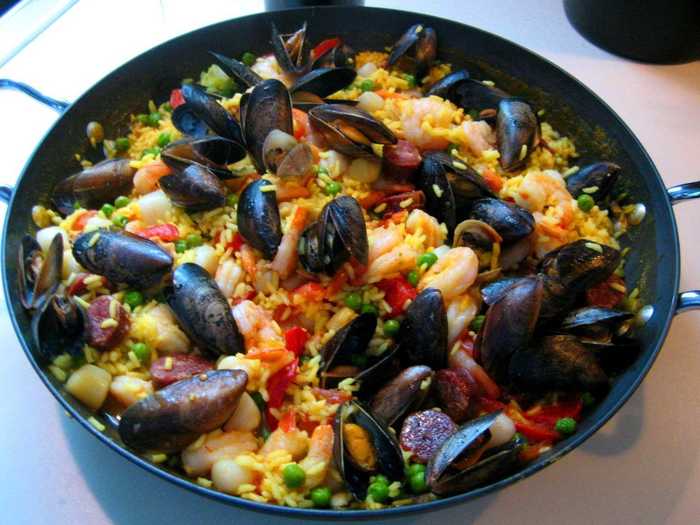 Share a pot of paella, saffron-infused rice with seafood and chorizo, with friends at famed Can Majó, a restaurant on the beach in Barcelona.