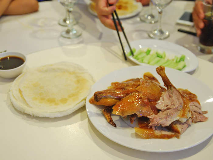 Wrap fresh-carved Peking duck up in a pancake with scallions and hoisin sauce in Beijing, China.