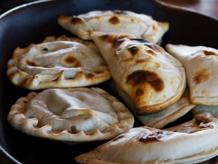 Bite into a crispy, crunchy empanada filled with meat, cheese, or vegetables in Santiago, Chile.