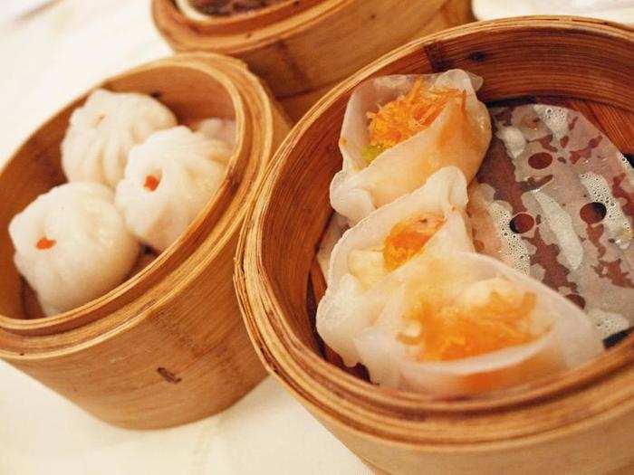 Sample dozens of bite-sized morsels—dumplings, pork buns, turnip cakes, noodles—at dim sum in Hong Kong.