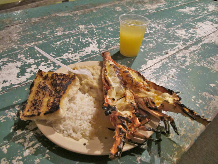 Crack open a fresh grilled lobster right on the beach in Caye Caulker, Belize.