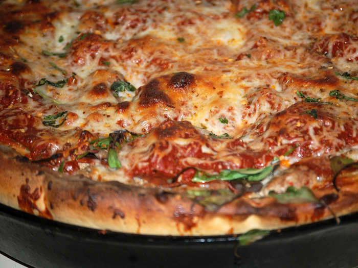 Dig deep into layers of the gooey, melted cheese and warm tomato sauce of a deep dish pizza in Chicago.