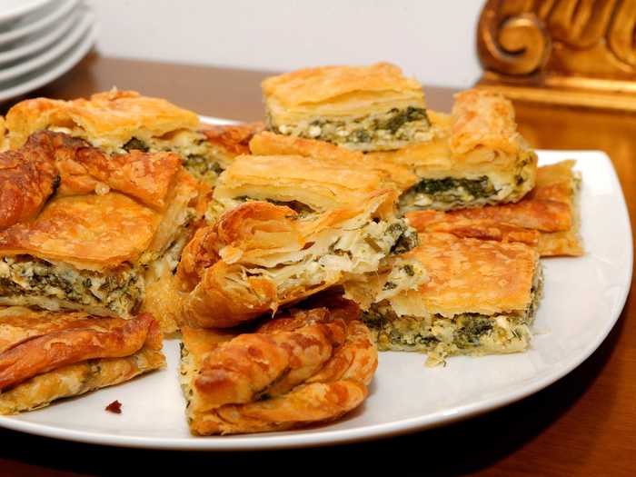 Peel off a crispy, flaky layer of fresh spanakopita, a feta-and-spinach pie that