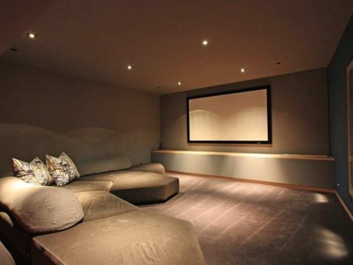 A screening room is set up with comfortable couches.