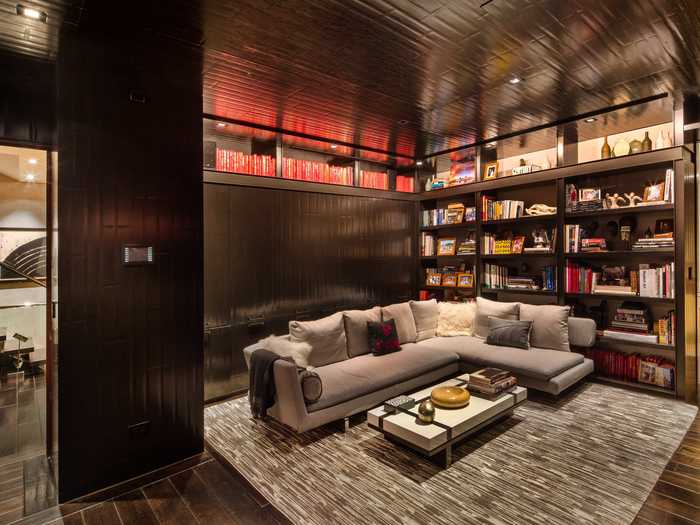 The study has unique bookshelves and cabinetry.