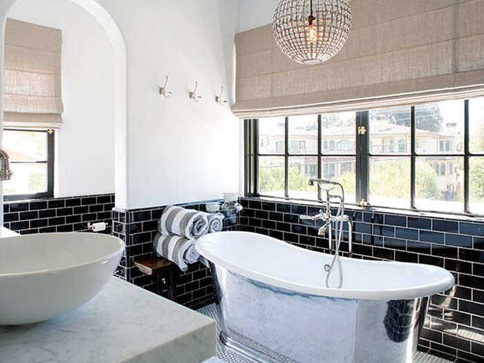 The master bath has gorgeous black tile and a stand-alone tub.