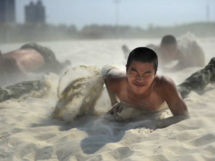 ... and crawl through sand in 102-degree heat.