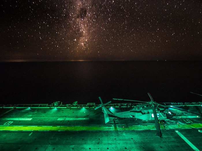 An MH-60S Sea Hawk helicopter is readied for launch during flight operations aboard the amphibious assault ship USS Bonhomme Richard.