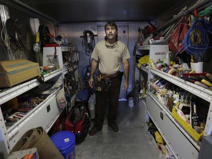 Carlos Hernandez, 45, poses in his workshop in Miami. Hernandez said he was a youth baseball star in Cuba when he decided to climb into a catamaran in 1994 and head for the U.S.